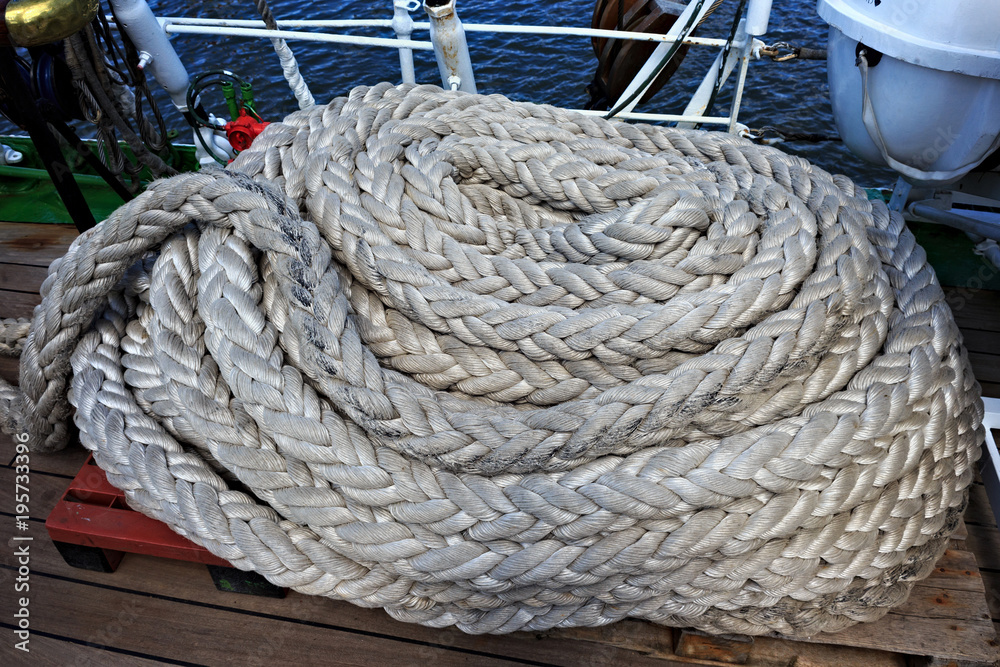 Thick white ropes on a sailing ship.