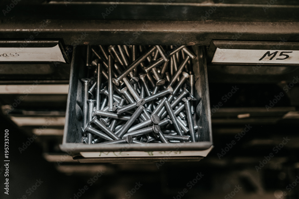 Fototapeta premium a film cenamatic style looking of nails organized by a big metal drawers