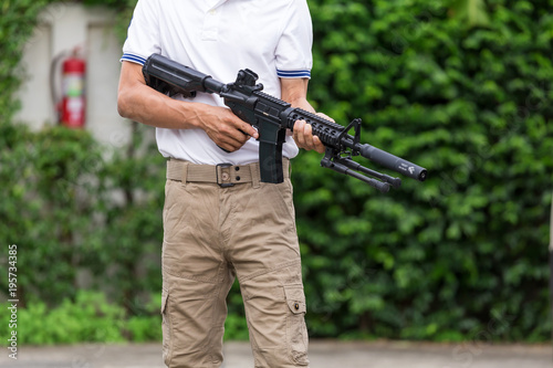 man in cargo pants with gun