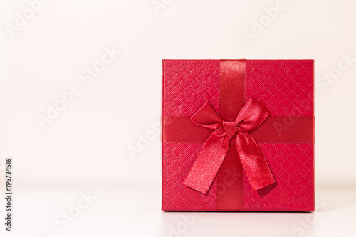 Red gift box on wooden plank. Concept for valentine day.