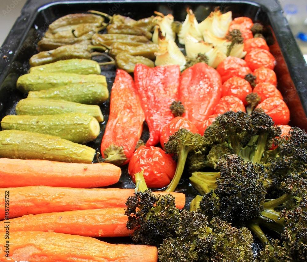 Vegetables for grilling on a black tray