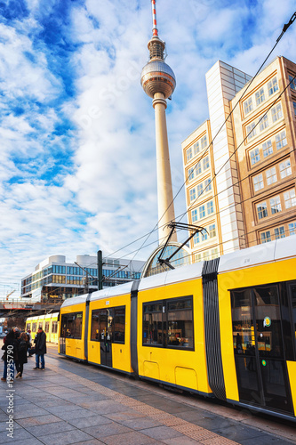 Running tram on Alexanderplatz with television tower in Berlin photo