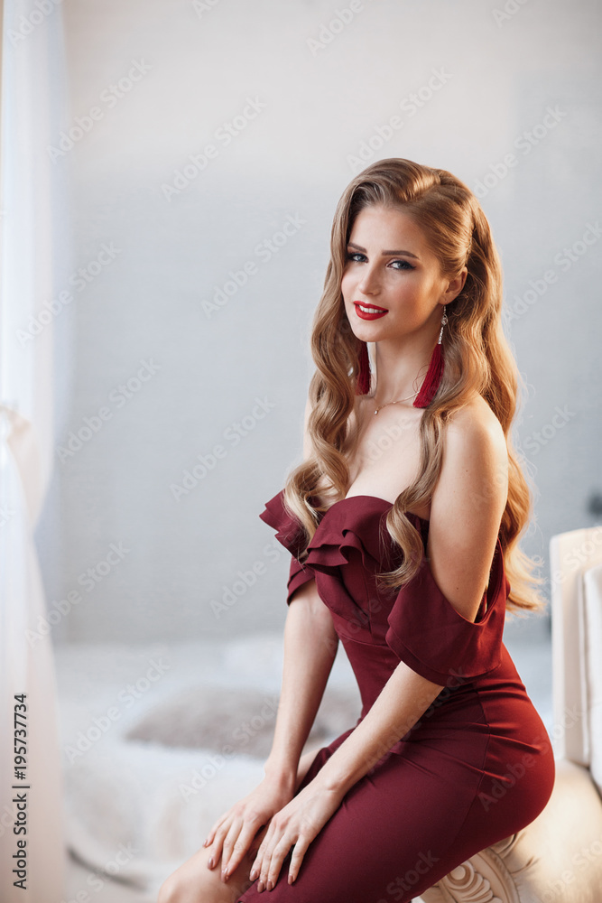 Beautiful sexy lady in an elegant burgundy dress. Close up fashion portrait of model indoors. Beautiful young brunette woman with stylish make-up. Attractive woman in an open dress Beautiful sexy lady in an elegant burgundy dress. Close up fashion portrait of model indoors. Beautiful young brunette woman with stylish make-up. Attractive woman in an open dress