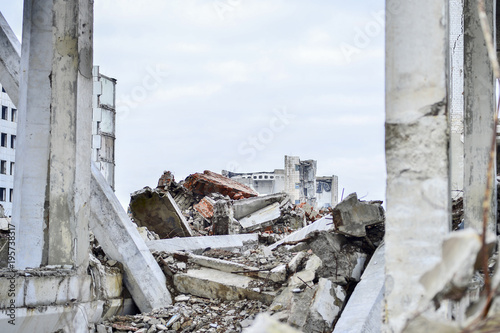 Remains of the destroyed industrial building. Large concrete piles continue to hold the body of the large concrete buildings, while others look at the sky.