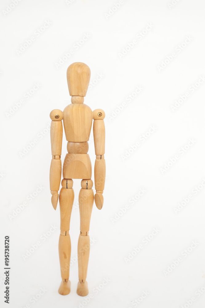 The wooden dummy stands straight. On a white background. The wooden dummy stands straight. On a white background.