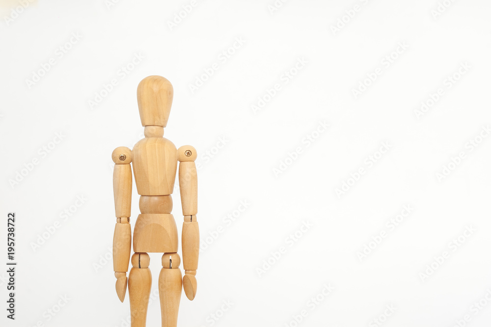 The wooden dummy stands straight. On a white background. The wooden dummy stands straight. On a white background.