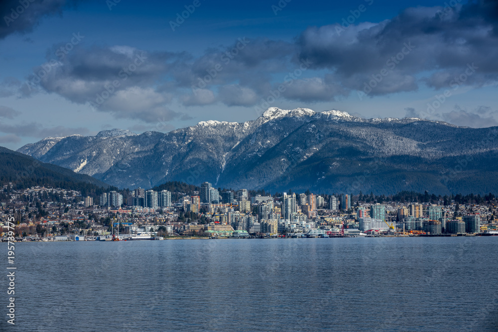 Fototapeta premium Rocky Mountains and buildings, North Vancouver, British Colombia, Canada.