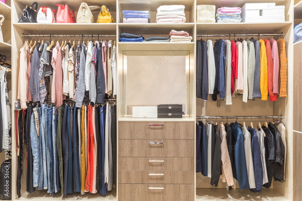 Modern wooden wardrobe with clothes hanging on rail in walk in closet  design interior Stock Photo | Adobe Stock