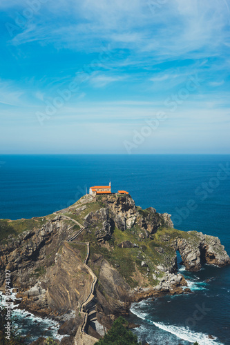 Sea scape on background gaztelugatxe steps sun huan, nature horizon ocean, relax holiday, blank space blue waves view, travel trip on Basque country in Spain, popular place of movies photo