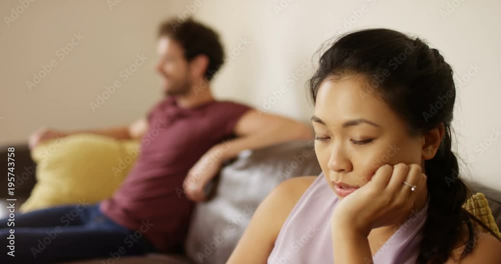 4K Depressed woman in bad relationship sitting apart from partner after argument. Slow motion. 4K Depressed woman in bad relationship sitting apart from partner after argument. Slow motion.