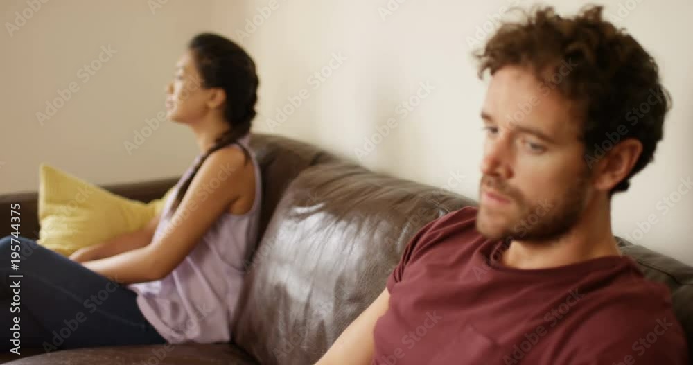4K Depressed man in unhappy relationship sitting apart from partner after argument. Slow motion. 4K Depressed man in unhappy relationship sitting apart from partner after argument. Slow motion.