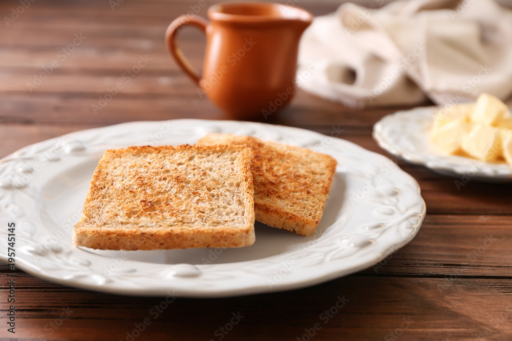 Plate with tasty toasted bread on wooden table Plate with tasty toasted bread on wooden table