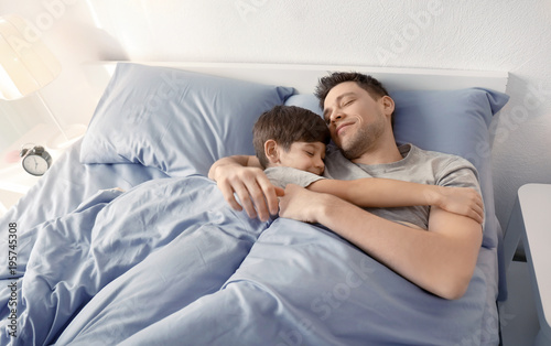 Father with son sleeping in...