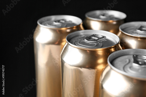 Cans of beer on black background, closeup