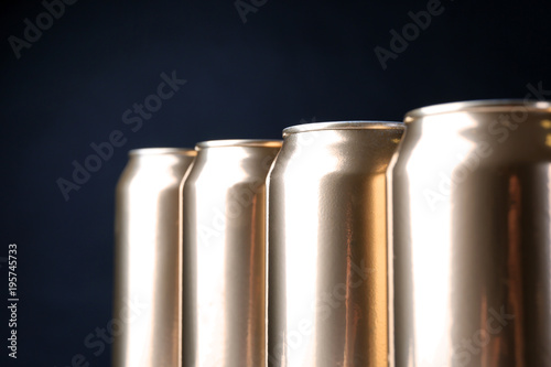 Cans of beer on dark background, closeup
