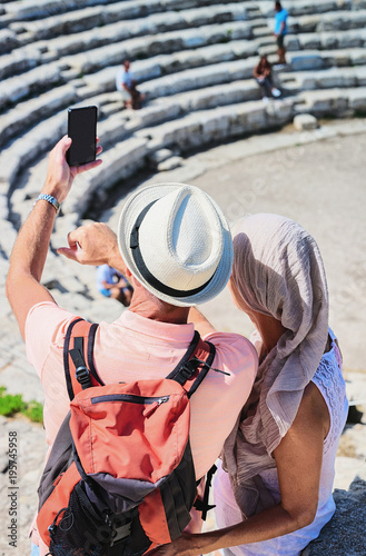 People taking photos at old theater in Segesta