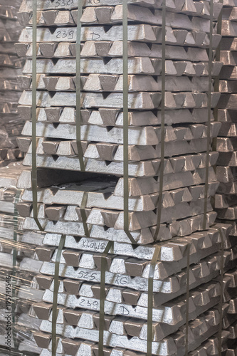 Close up of Aluminum on pallet Ingot storage in indoor warehouse for export as industrial background. Aluminium bullion on pallet