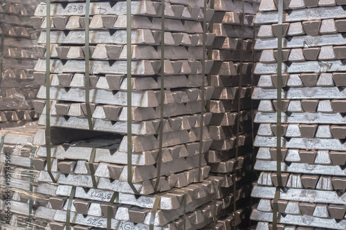 Close up of Aluminum on pallet Ingot storage in indoor warehouse for export as industrial background. Aluminium bullion on pallet