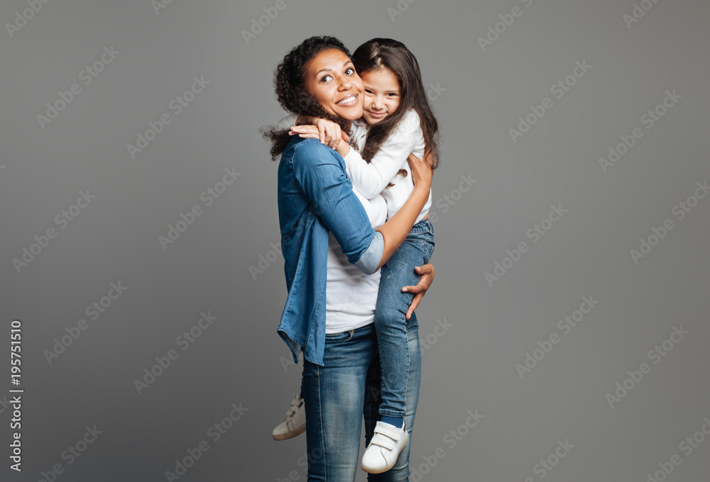 Positive smiling mother holding her preteen daughter Positive smiling mother holding her preteen daughter