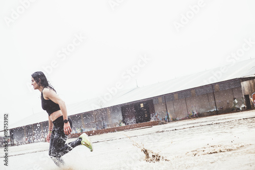 Woman doing sport in the open air, on rainy day