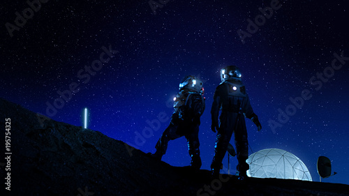 Vászonkép Two Astronauts in Space Suits Stand on the Moon Looking at the Beautiful Nght Sky Full of Stars