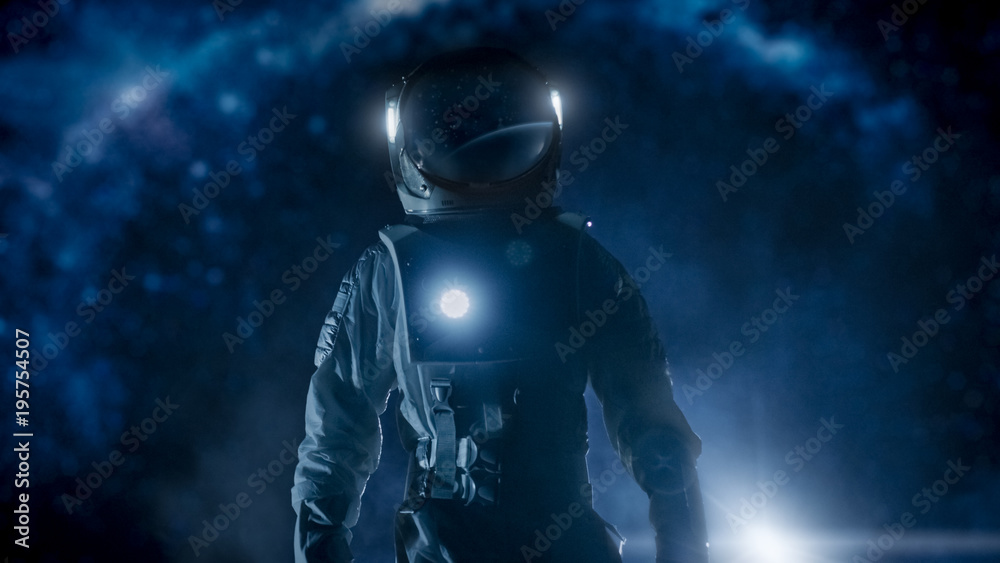 Courageous Astronaut in the Space Suit with Flashlight Explores Mysterious Alien Planet. The Milky Way Galaxy in Background. Adventure. Space Travel, Habitable World and Colonization Concept. Courageous Astronaut in the Space Suit with Flashlight Explores Mysterious Alien Planet. The Milky Way Galaxy in Background. Adventure. Space Travel, Habitable World and Colonization Concept.