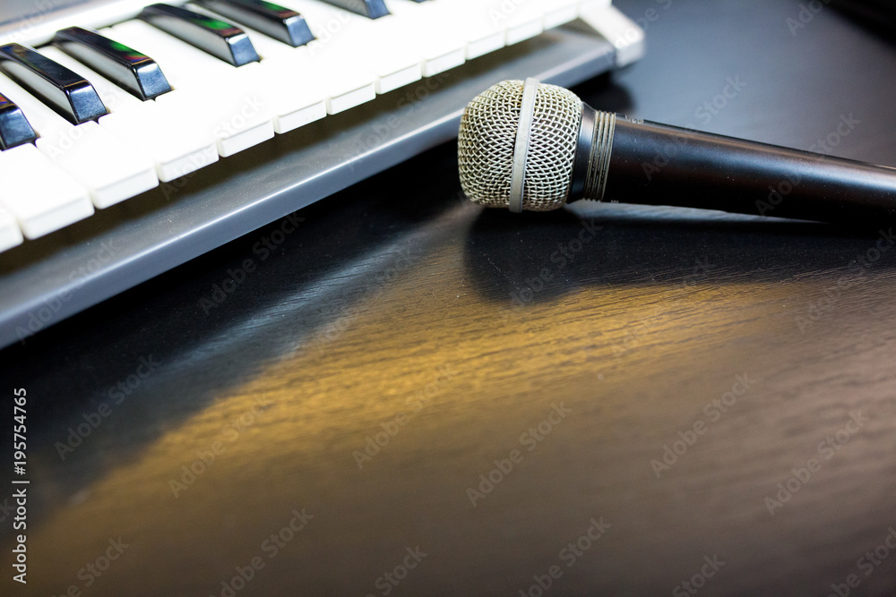 Obraz premium Image of keyboard with microphone on black background.