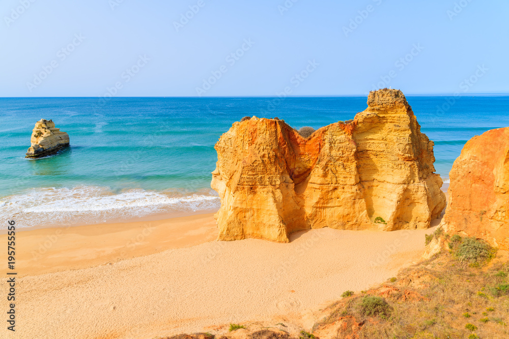 Rocks on beautiful sandy Praia da Rocha beach in Portimao town, Algarve, Portugal
