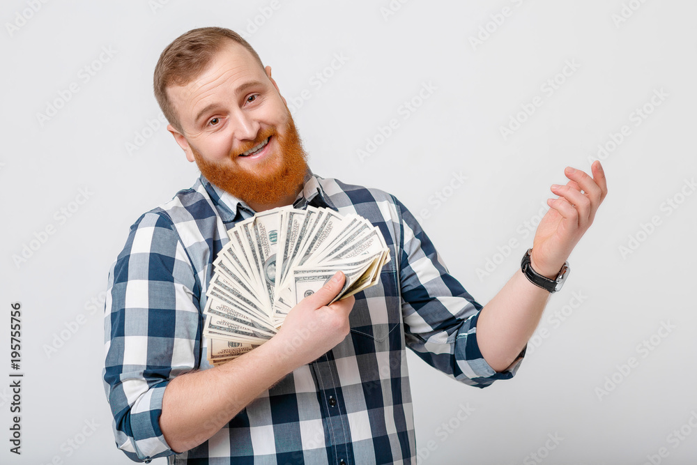man with beard holding lot of hundred-dollar bills man with beard holding lot of hundred-dollar bills
