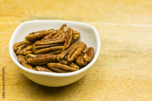 Bowl with shelled pecan nuts.