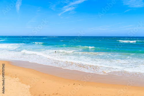 A view of sandy Praia do Amado beach and sea with waves  Portugal