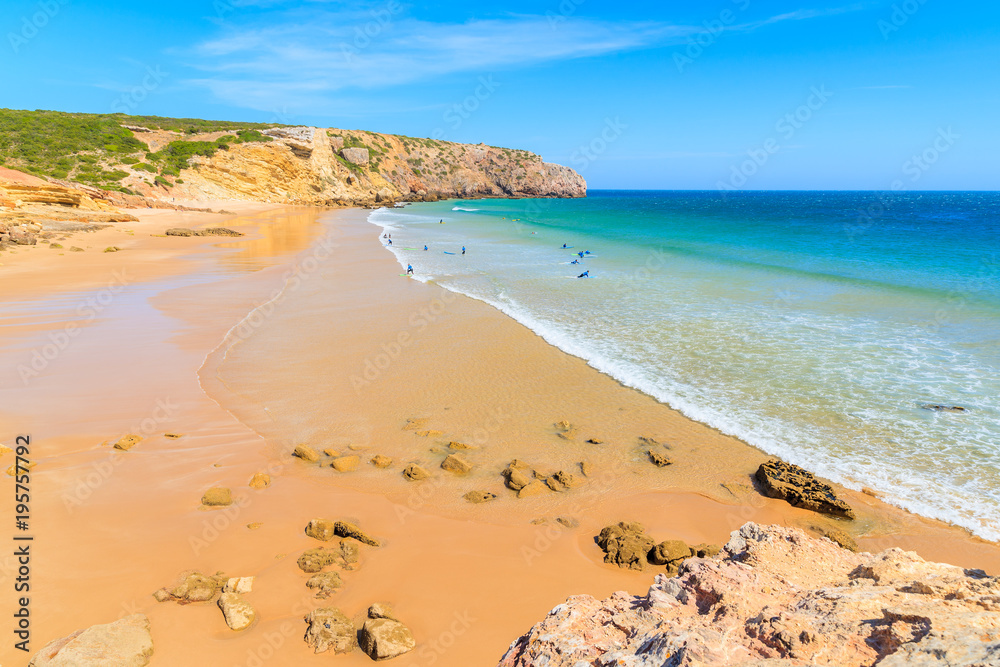People surfing on beautiful Zavial beach on sunny beautiful day, Algarve, Portugal