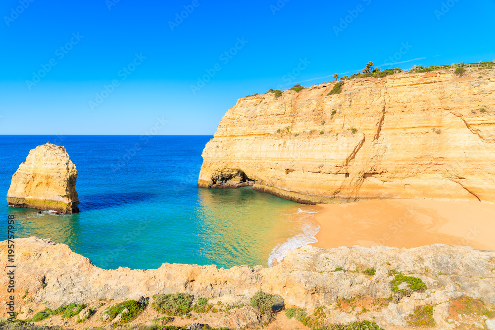 Fototapeta premium A view of secluded beautiful beach and cliffs on coast of Portugal near Carvoeiro town