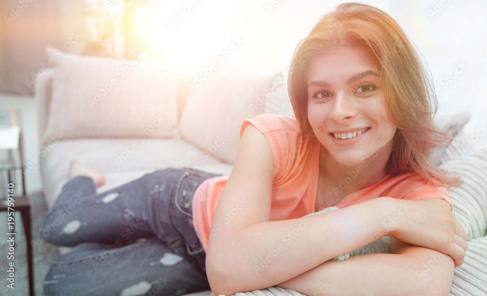 portrait of young woman relaxing at home on the couch. portrait of young woman relaxing at home on the couch.