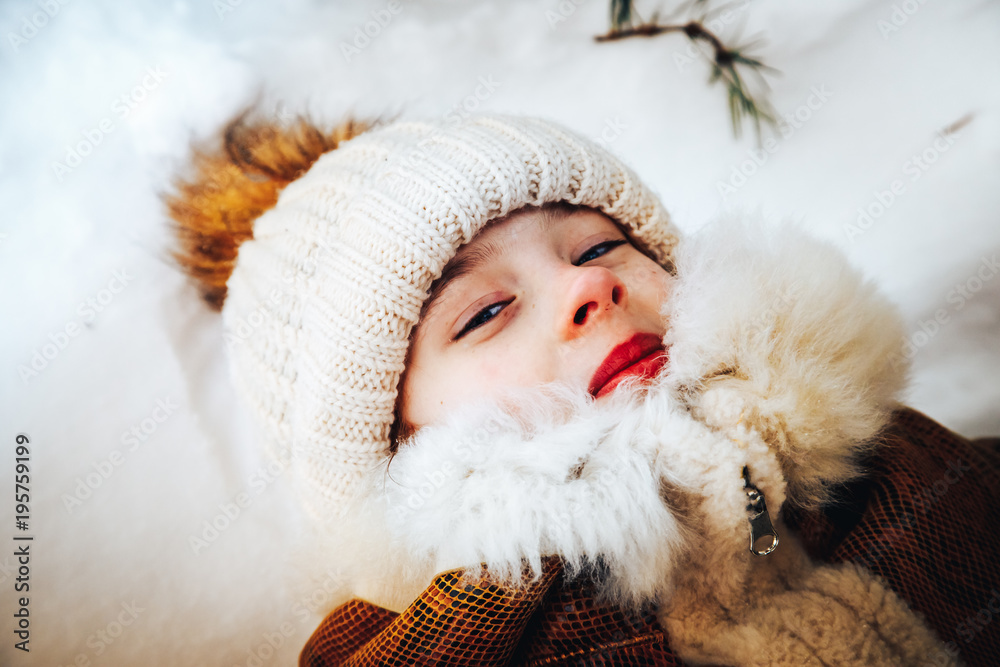 Portrait of a little girl in winter dress in a forest full of snow Portrait of a little girl in winter dress in a forest full of snow