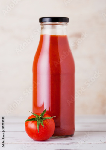 Glass bottle of tomato paste with raw  tomato