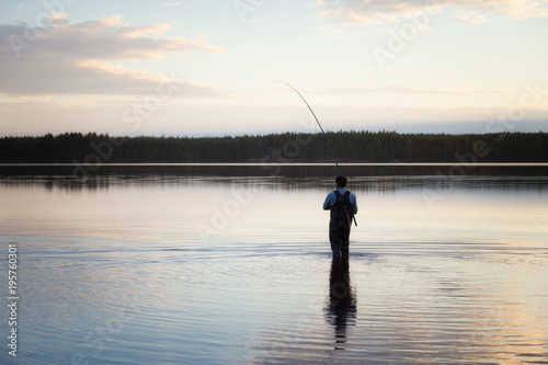 Man fishing on a beautiful quiet lake