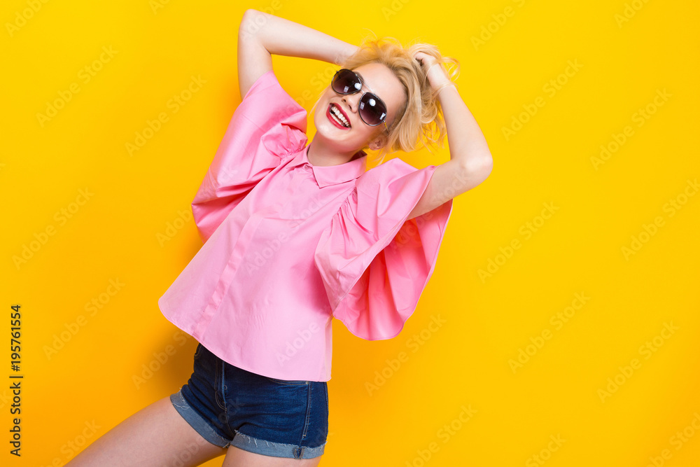 Happy blonde woman in pink blouse with sunglasses