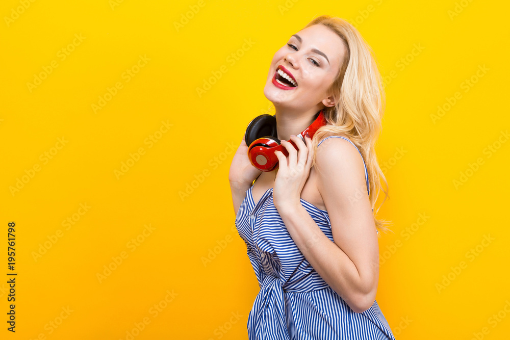 Blonde girl in blue striped blouse with headphones Blonde girl in blue striped blouse with headphones