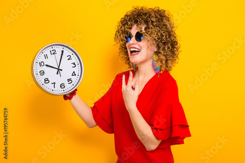 Attractive woman with short curly hair with clocks photo