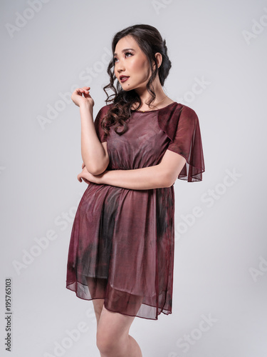 Beautiful Female Asian Model in red dress photo