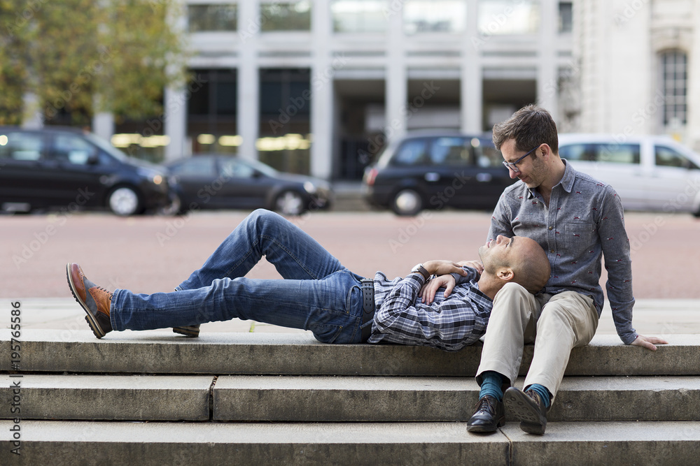 Gay couple relaxing in the city