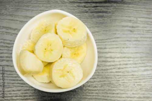 Bowl with fresh pieces of banana. View from above.