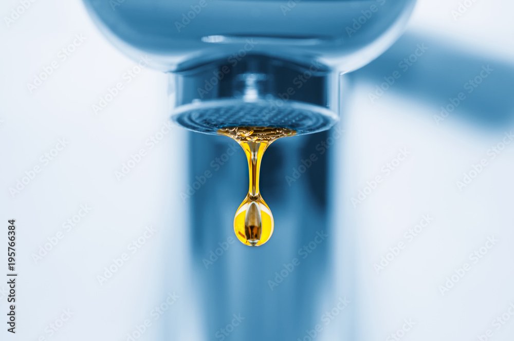 Blue tap and golden drop close up Blue tap and golden drop close up