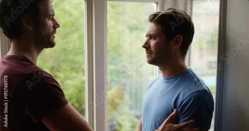 4K Loving gay male couple making up after a fight on a rainy day. Slow motion.