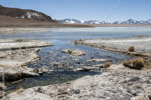 Laguna y Termas de Polques hot spring pool with Salar de Chalviri in background, Salar de Uyuni, Potosi, Bolivia - South America 