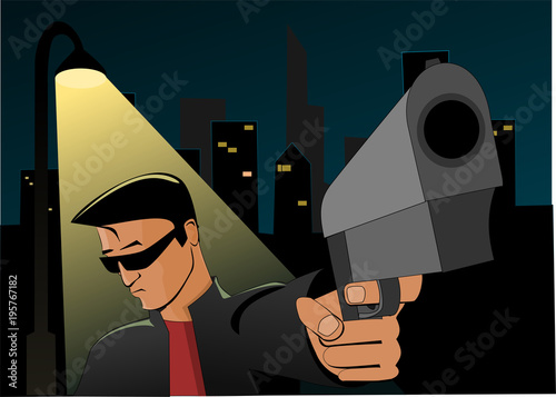 Young man with gun standing under street lantern