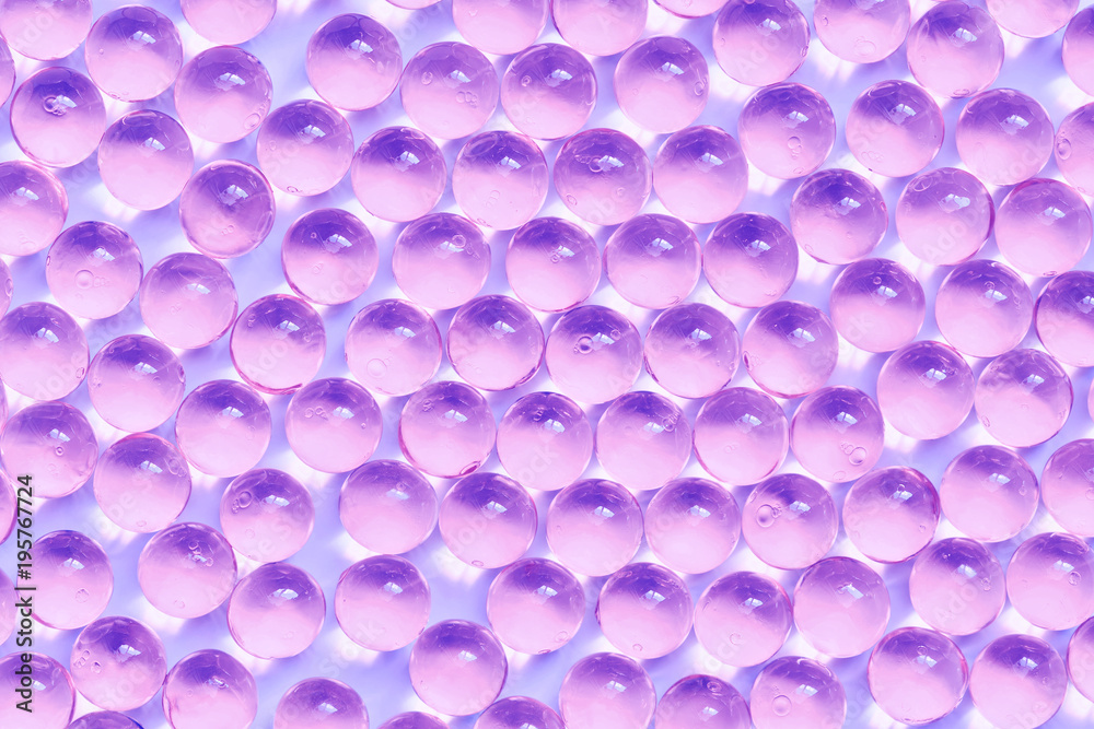 Background of jelly capsules. Jelly round capsules of purple color.