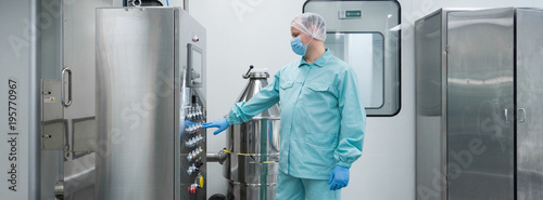 Картината върху платно Pharmaceutical factory man worker in protective clothing working with control pa