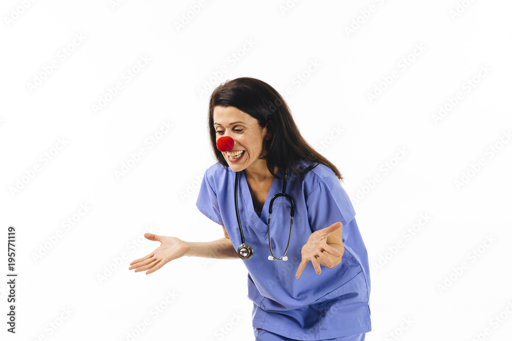 Portrait of a laughing female nurse or doctor with red nose Portrait of a laughing female nurse or doctor with red nose
